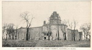 Postcard-style black and white photograph of a wide stone building with a dome.