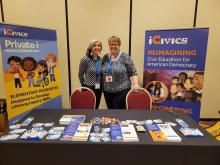 Kelley Brown and Laurie Risler stand between posters 'Reimagining Civic Education for American Democracy' and 'Private i History Detectives'