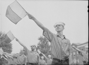 Men in sailor attire pointing flags in the same direction.