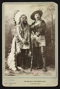 an american indian standing next to a soldier