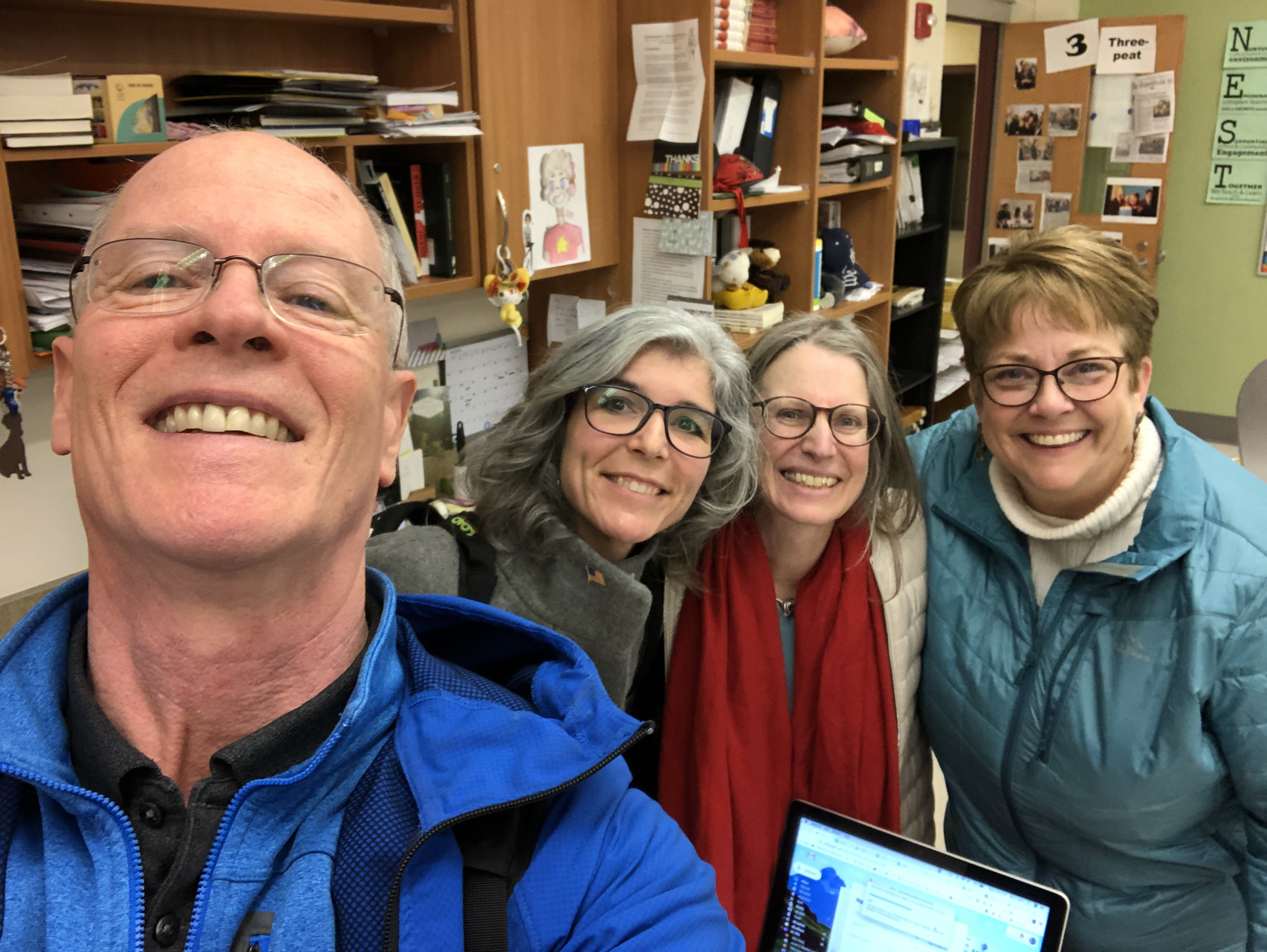 Emerging America's Rich Cairn takes a selfie in a classroom with Brown, Risler, and Alison Noyes.