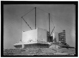 Photo of construction cranes raising base of Washington Memorial.