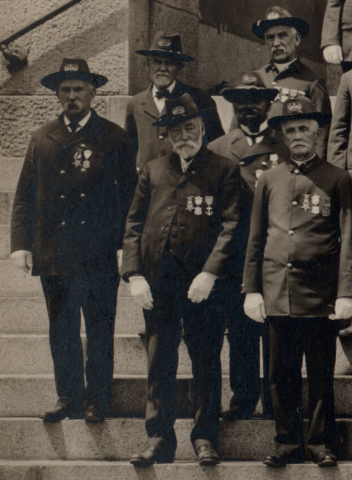 African American William Carney poses with white members of the New Bedford, Massachusetts post of the Grand Army of the Republic, all in uniform.