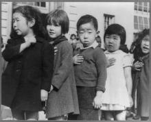 San Francisco, Calif., April 1942. First-graders, some of Japanese ancestry, at the Weill public school pledging allegience to the United States flag. The evacuees of Japanese ancestry were housed in War relocation authority centers for the duration of the war